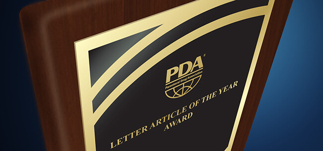 A bronze plaque mounted on wood with the PDA logo at top and text that reads Letter Article of the Year Award