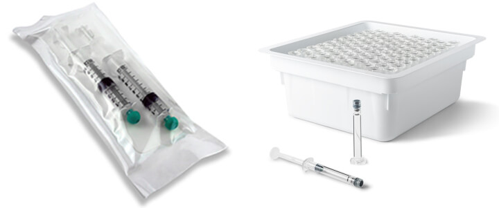 A sealed bag of 2 prefilled syringes on the left, at right a bin filled with small lumens