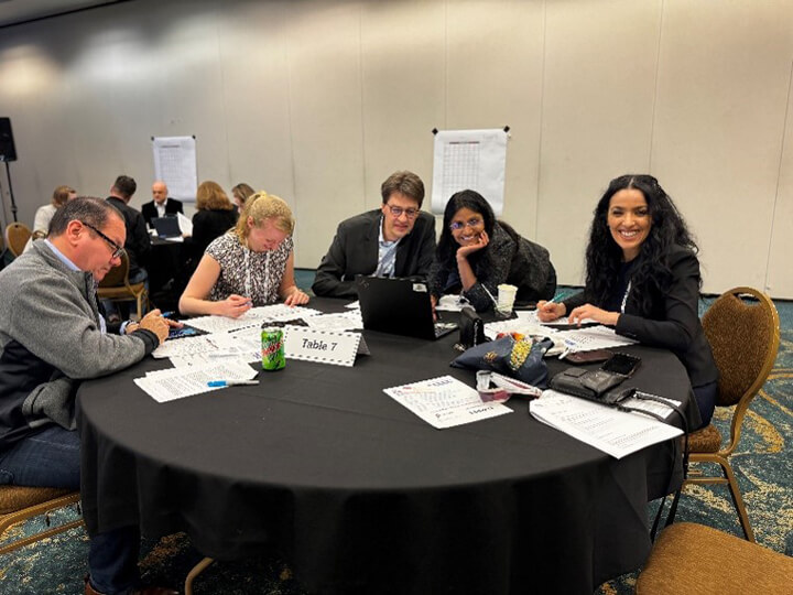 Attendees at a round table working on a case study