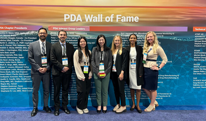 Members of the PDA West Coast Chapter standing in front of the PDA Wall of Fame at 2024 PDA Week